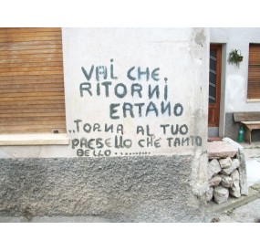 Old graffiti regarding the disaster, in Erto town center